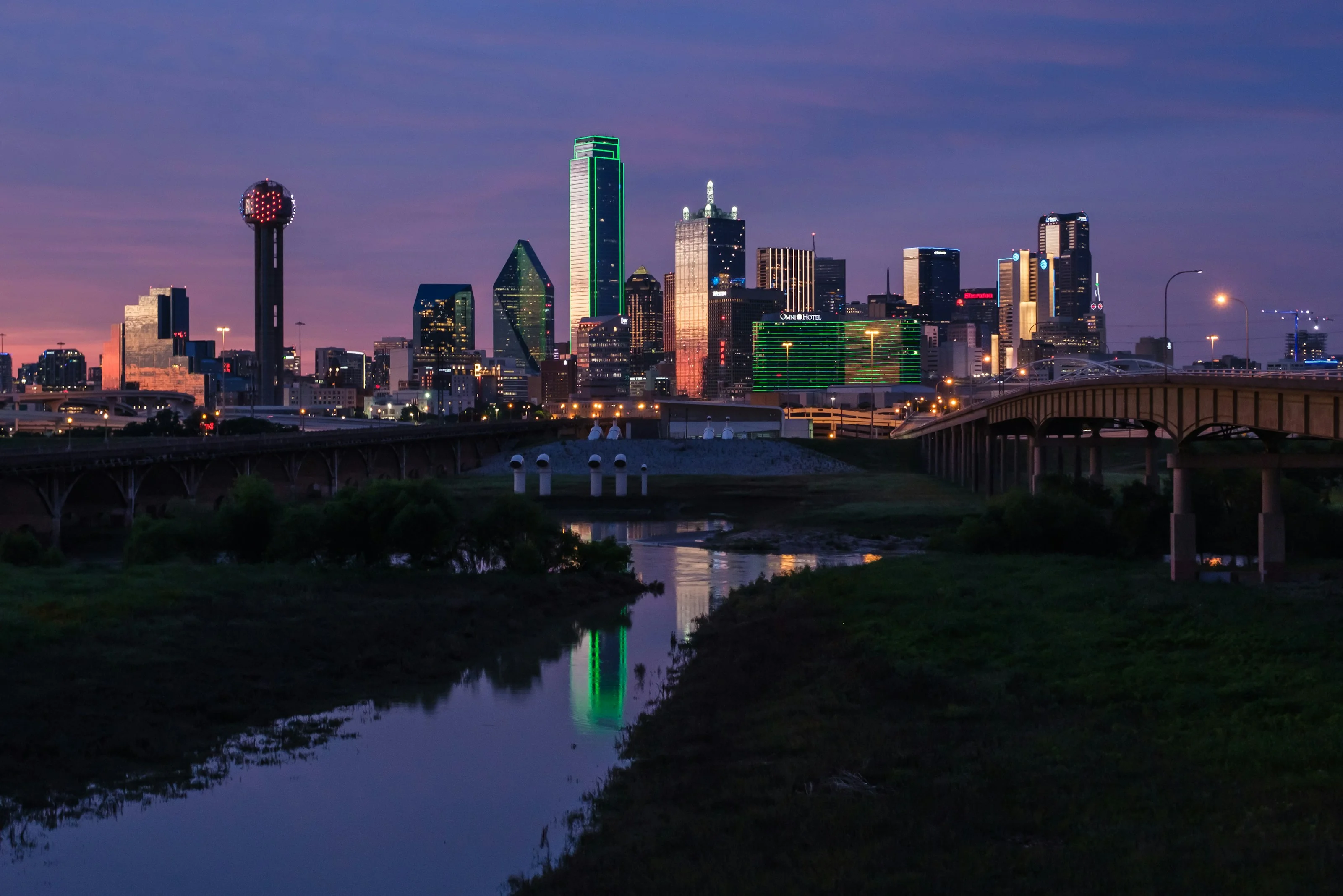 Downtown Dallas skyline seen across the Trinity River at twilight
